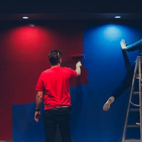 man and woman painting wall